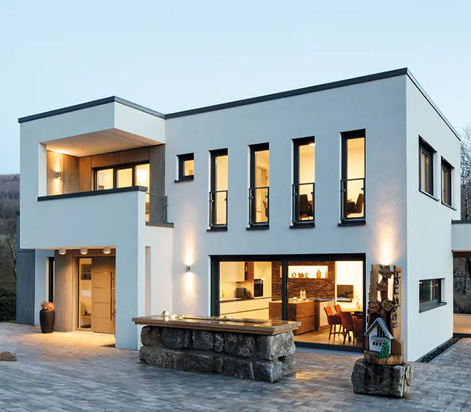 Maison contemporaine avec menuiseries aluminium Schüco sur mesure : grandes fenêtres et baies vitrées offrant une luminosité exceptionnelle et une connexion parfaite entre intérieur et extérieur.