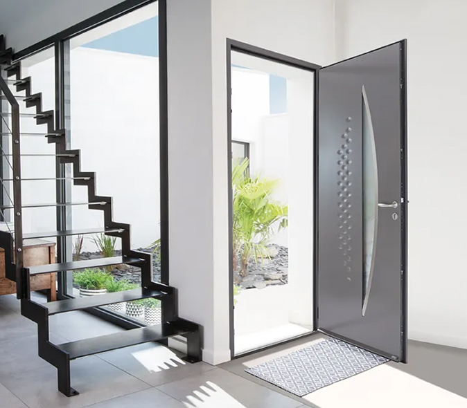 Porte d’entrée en acier gris au design contemporain avec vitrage décoratif, dans une maison moderne